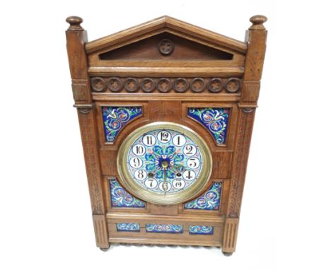 An Aesthetic carved oak mantel clock after a design by Lewis Foreman Day, having architectural cornice, Gothic style pierced 