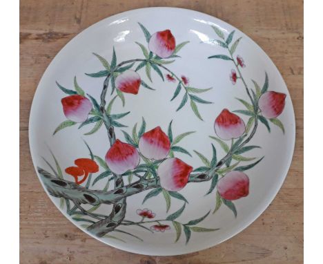 A Chinese porcelain dish decorated in over enamels with flowers, bearing red seal to base, diam. 36.5cm.  Condition - very go