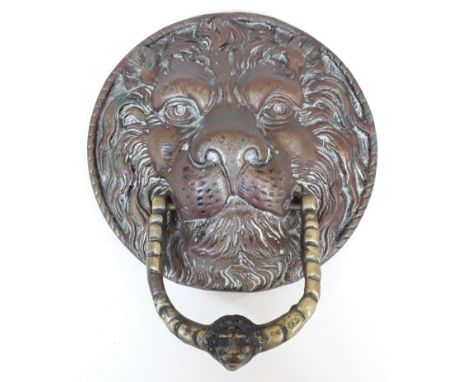 A cast brass door knocker formed as a lion mask with loop handle, diam. 17.5cm.