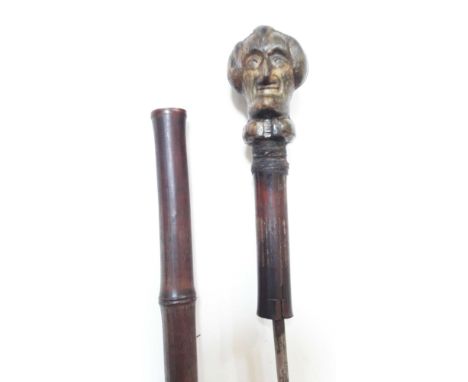 A cane sword stick circa 1900, the finial carved with Dr Syntax, length 88.5cm.Condition: blade length 43cm, minor losses to 