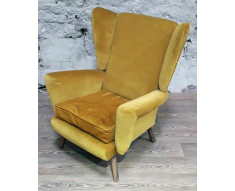 A mid 20th century mustard yellow wing back armchair, width 80cm, depth 83cm & height 94cm.Condition: minor wear to cushion a