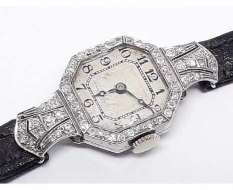 A ladies 18ct white gold and diamond encrusted Art Deco cocktail watch, length 38mm, with later leather strap  