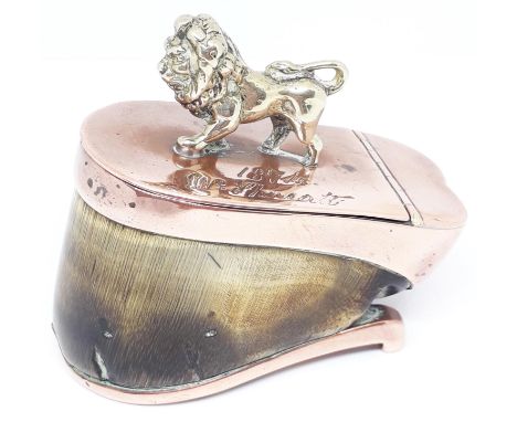 A Victorian copper mounted horse hoof snuff box, the lid indistinctly inscribed, dated 1874 and mounted with brass lion finia