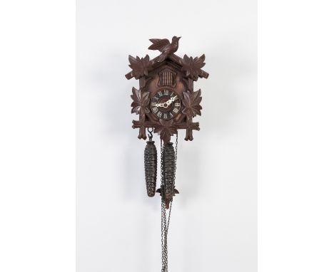 MODERN BLACK FOREST CARVED SOFTWOOD SMALL CUCKOO CLOCK, with pine cone pattern weights, together with a FLORAL MARQUETRY INLA