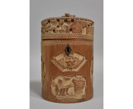 A Chinese Cylindrical Bamboo Tea Caddy having Intricately Carved Decoration Depicting Elder Scholars, Birds Etc. 19cms High 