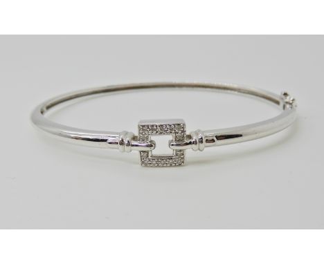 A 9ct white gold diamond set bangle, Inner diameter 5.8cm, weight 8.5gms