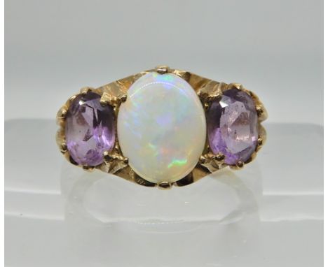 A 9ct gold amethyst and white opal three stone ring with scroll mount. Finger size approx M, weight 3.8gms