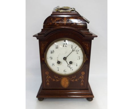 A French mahogany inlaid mantle clock, 30cm high