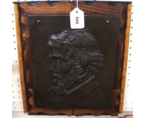 A bronze plaque of Thomas Carlyle by T.S. Burnett on wooden backing, plaque 25 x 31cm