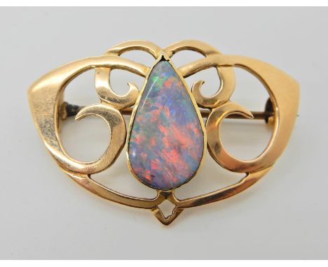 A 15ct gold Art Nouveau brooch set with a opal doublet dimensions of opal 15.2mm x 8.7mm, dimensions of the brooch 3.6cm x 2.