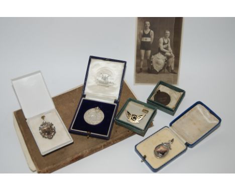 A collection of silver and bronze medals relating to Royal Life Saving Society, various postcards etc