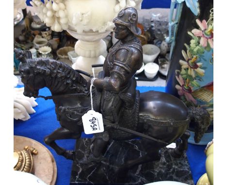 A bronze of a warrior on horseback, mounted on marble base