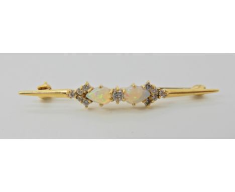 An 18ct gold opal and diamond brooch, dimensions 4.6cm x 0.5cm, weight 3.1gms