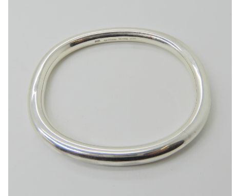 A silver Danish bangle designed by Erik Boy Johansen, inner diameter 6.4cm x 5.7cm, weight 84.7gms