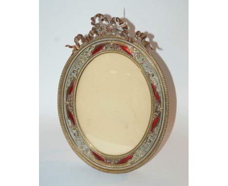 A 20th Century gilt-metal oval picture frame with decorative finial, on easel stand, 33cm overall