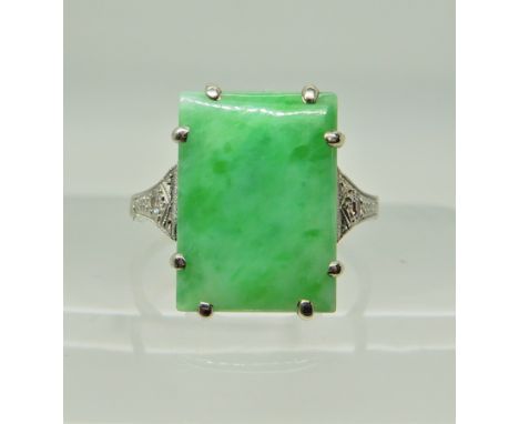 A white metal Chinese green hardstone Art Deco ring with diamond accents to the shoulders, the inner shank inscribed Florence