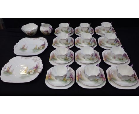 A SHELLEY URN DESIGN 12 SETTING TEA SET comprising; cups, saucers, side plates, 2 serving plates, milk jug and sugar bowl (so