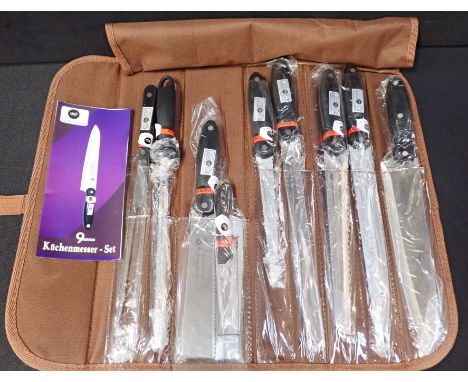 AN UNUSED SET OF CHEFS KNIVES Kuchenmesser 7 knives, fork and sharpener (BEHIND COUNTER)