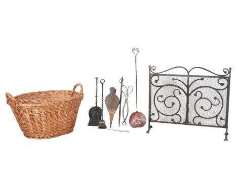 A WROUGHT IRON FIRE SCREEN 54cm high, together with a wicker basket and a collection of fire tools (a lot)