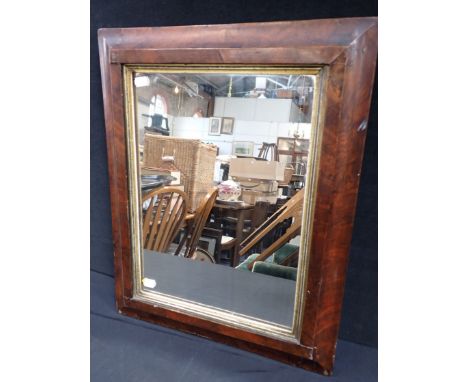 A 19TH CENTURY WALNUT FRAMED MIRROR with concave moulding and gilt slip 45 x 56cm (damage to veneer)