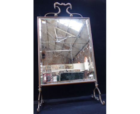 AN EDWARDIAN BRASS-FRAMED FIRE SCREEN with bevelled plate 79cm high