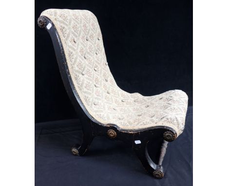A VICTORIAN CHILD'S EBONISED SLIPPER CHAIR upholstered in later buttoned tapestry and with applied brass roundels, 66cm high