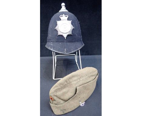 A VINTAGE CHRISTY'S POLICE HELMET with Hull City Police badge, and a military woollen cap with Colloquial German Speaker badg