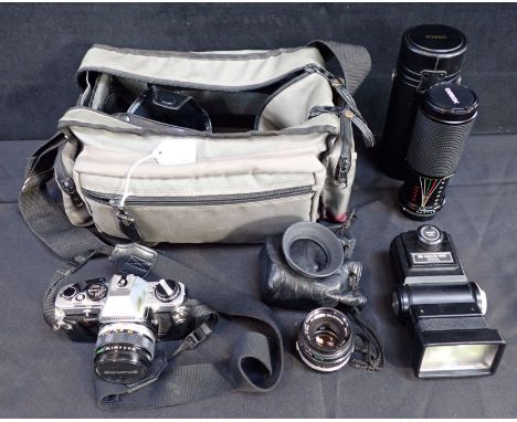 AN OLYMPUS CM10 35MM SLR CAMERA together with an Ozeck 75-300mm lens, two Olympus lenses and a Vivitar flash, contained in fi