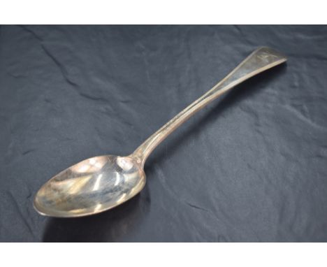 A George IV silver Old English Thread pattern serving spoon, engraved with crest 'A Dexter arm embowed in armour holding a bo