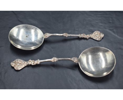 A pair of Edwardian silver trefoil spoons, of medieval design the the shallow circular bowls with slender cast stems with tre