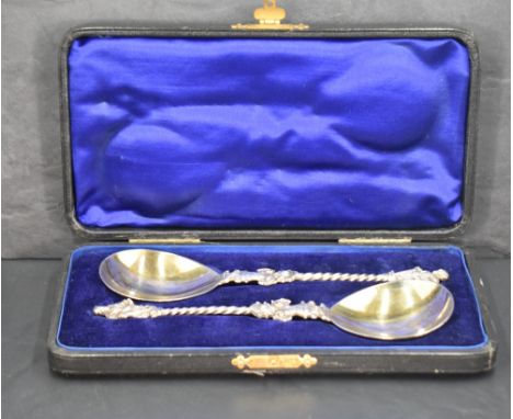 A cased pair of late Victorian apostle spoons, having pear-shaped bowls with figural join, twisted stems and figural terminal