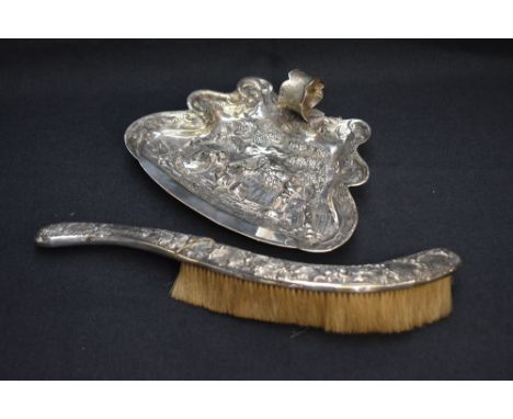 A late 19th/early 20th century silver plated crumb brush and tray, each relief moulded with medieval rural village scene with