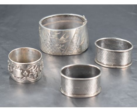 A Burmese white metal napkin ring, of compressed circular form decorated with a band of deities, unmarked, 38grams, sold alon