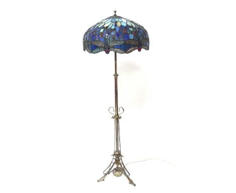 An Art Nouveau silvered brass three-branch standard lamp, having telescopic action, with Tiffany style coloured lead domed gl