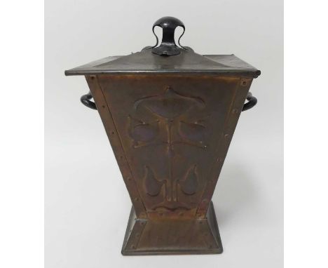 An Art Nouveau copper coal purdonium and cover, of square tapering form, having twin black painted iron carry handles and con