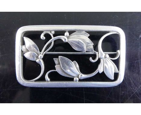 Georg Jensen (1866-1935) - a sterling silver rectangular openwork panel brooch, decorated with stylised flowers, with roller 