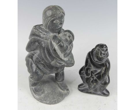 Eskimo Art - a carved grey stone figure group of a Mother and Child, in standing pose to a naturalistic base, indistinctly et