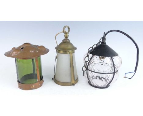 Three various circa 1900 hanging ceiling lights, to include an Arts &amp; Crafts embossed copper example, inset with green gl
