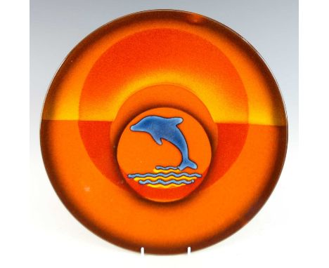 A large Poole Pottery limited edition circular charger, of dished form, flambé glazed with central leaping dolphin, printed m
