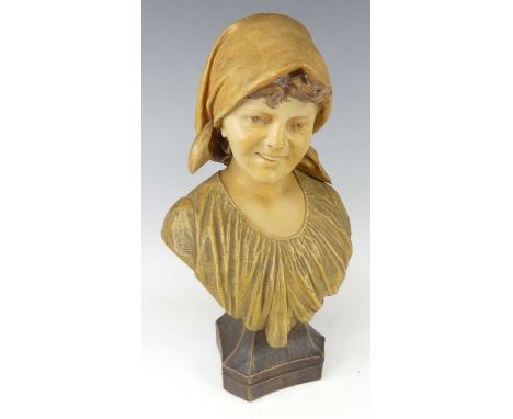 An Austrian Art Nouveau Goldscheider painted pottery female bust, looking to dexter and wearing headscarf, on raised integral