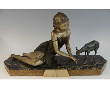 Attributed to Ugo Cipriani (1887-1960) - an Art Deco patinated spelter and marble figure group, modelled as a young woman in 