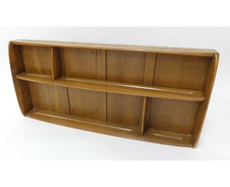 An Ercol blond elm sectional wall shelf, having panelled back and routed plate holders, 49.5 x 106.5cm 