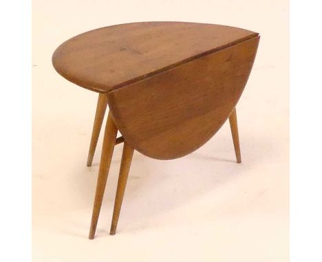 A 1960s Ercol blond elm low single drop flap occasional table, having gate-leg action, on turned tapering supports, h.40.5cm,