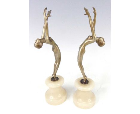 After Josef Lorenzl - a pair of 1930s patinated art metal nude model dancers, each standing on tiptoes with arms raised and h