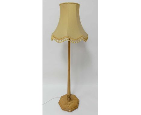 An Art Deco birch standard lamp, having hexagonal tapering column to lower acanthus leaf carved capping, raised on confirming