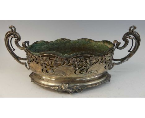 A large Art Nouveau silver plated twin handled centrepiece, of oval form, the pronounced scroll handles to floral pierced and