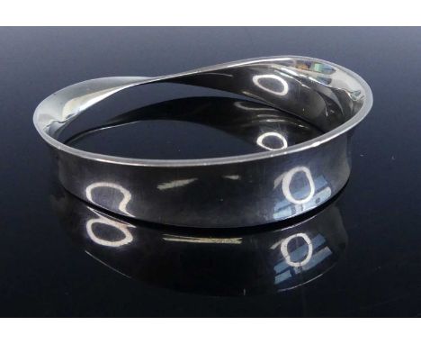 Vivianna Torun Bülow-Hübe (1927-2004) for Georg Jensen (1866-1935) - a sterling silver 'Mobius' bangle, designed 1968, of kin