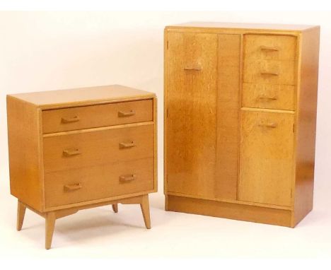 Ernest Gomme for G-Plan - a 1960s light oak two piece bedroom suite, comprising; compactum with an arrangement of single door