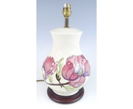 A contemporary Moorcroft Magnolia pattern pottery table lamp, of lower bulbous form, underglaze painted and tube-line decorat