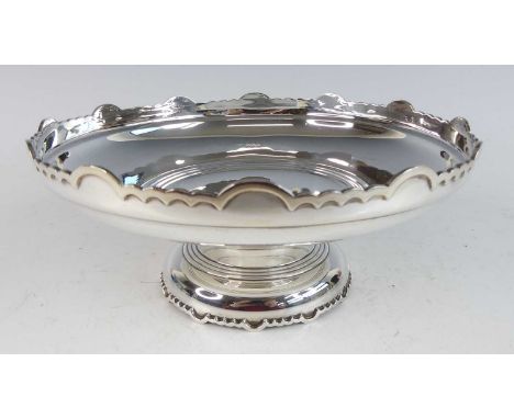 A late Art Deco silver footed tazza, having a raised and shaped opposing upper and lower edge to domed foot, with reeded deta